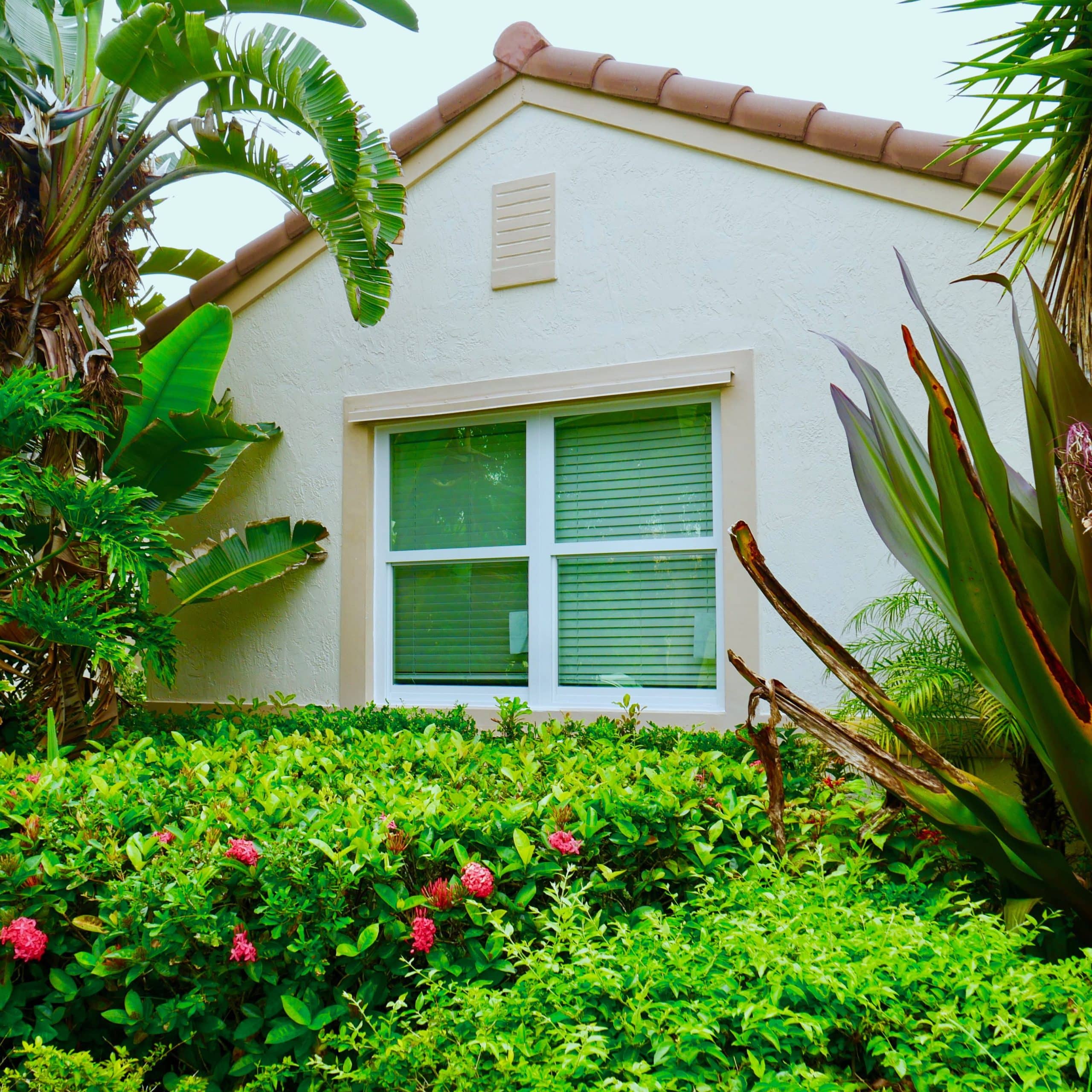 Installed impact window with roll-down shutter housing